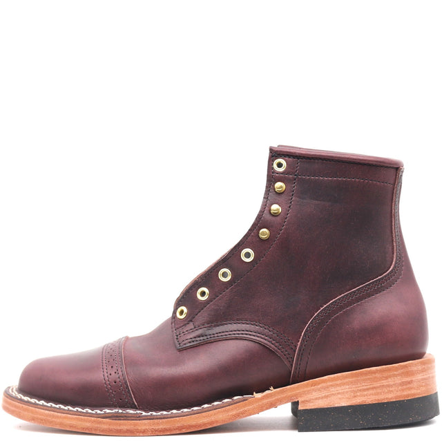A single dark burgundy leather ankle boot with brass eyelets, a tan wood-look midsole, and a black outsole, shown from a side profile on a white background.