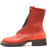 A single red leather lace-up ankle boot with silver metal eyelets and a dark brown sole, shown from a side profile on a white background.