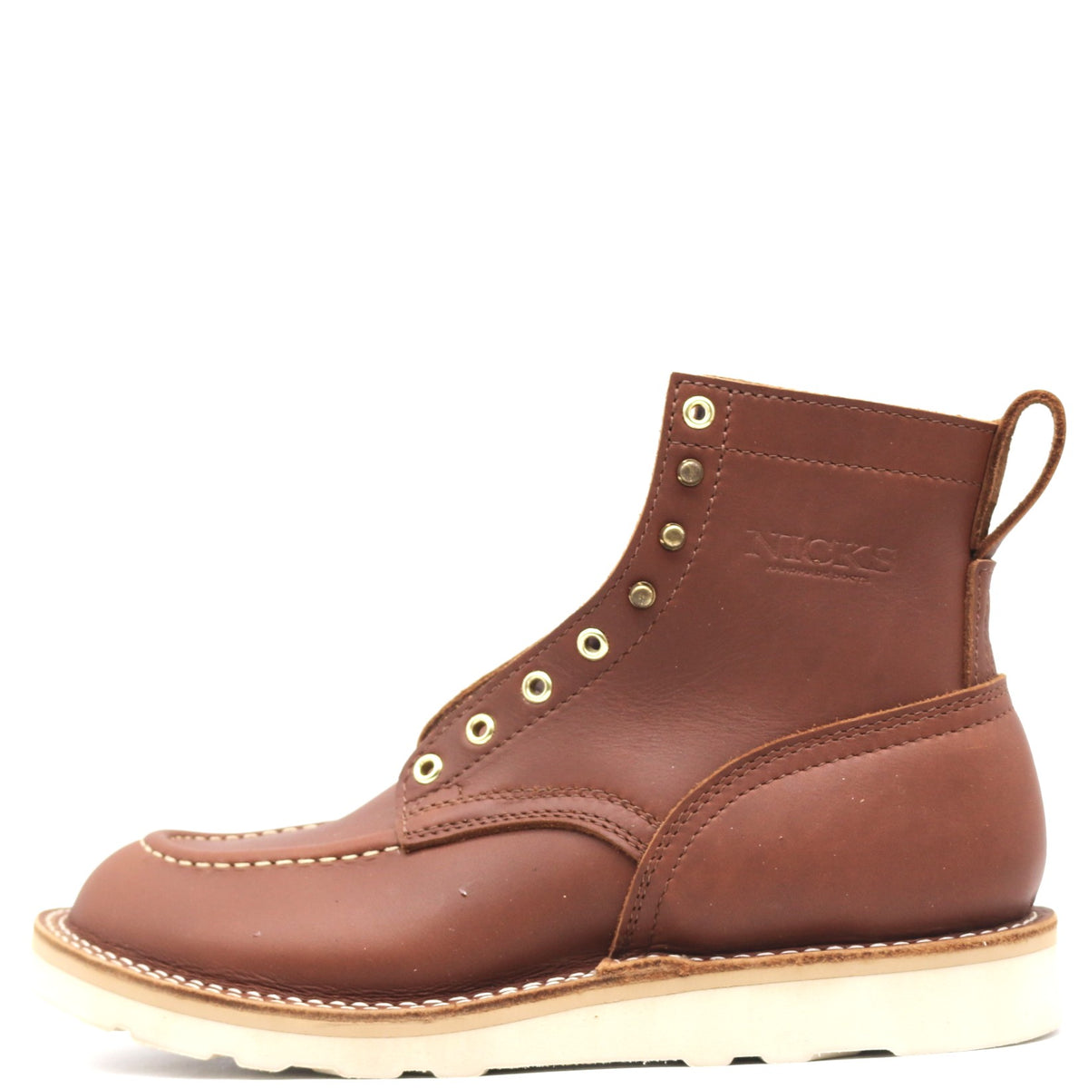A brown leather ankle boot with brass eyelets, white contrast stitching, and a thick off-white sole, shown from a side profile on a white background.