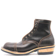 A single black leather lace-up ankle boot with a cap toe, decorative stitching, and a stacked wood-and-leather heel, shown from a side profile on a white background.