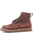Brown suede leather boot with brass hardware and a brown wedge outsole in front of a white background.