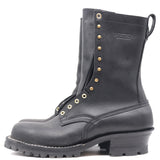 A black leather work boot with gold-tone metal eyelets, studs, and a pull tab, shown from a side profile on a white background. The brand name 'NICKS' is embossed on the side.
