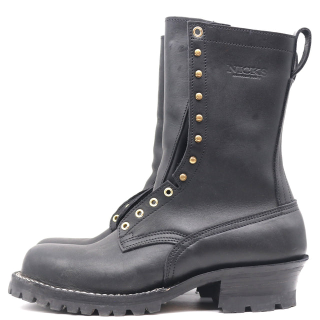 A black leather work boot with gold-tone metal eyelets, studs, and a pull tab, shown from a side profile on a white background. The brand name 'NICKS' is embossed on the side.