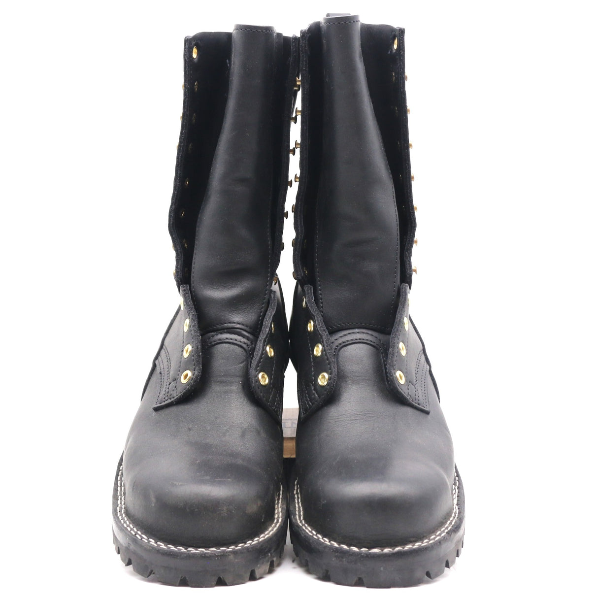 A pair of black leather mid-calf boots with gold-tone metal studs and eyelets, shown from the front against a plain white background.