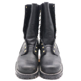 A pair of black leather mid-calf boots with gold-tone metal studs and eyelets, shown from the front against a plain white background.