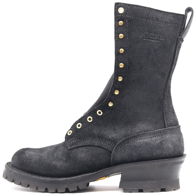 A black suede lace-up work boot with gold-tone metal studs and eyelets, a thick black lug sole, and a stacked heel, shown from a side profile on a white background.