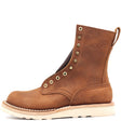 A brown leather ankle boot with gold-tone metal eyelets, a pull tab, and a thick off-white sole, shown from a side profile on a white background. The brand name 'NICKS' is embossed on the side.