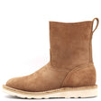 A single mid-calf ankle boot in brown suede, featuring a pull tab at the heel and a thick off-white sole with decorative stitching, shown against a plain white background.