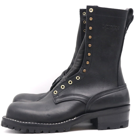 A pair of black leather lace-up boots with brass eyelets and studs, shown from a side profile view against a white background.