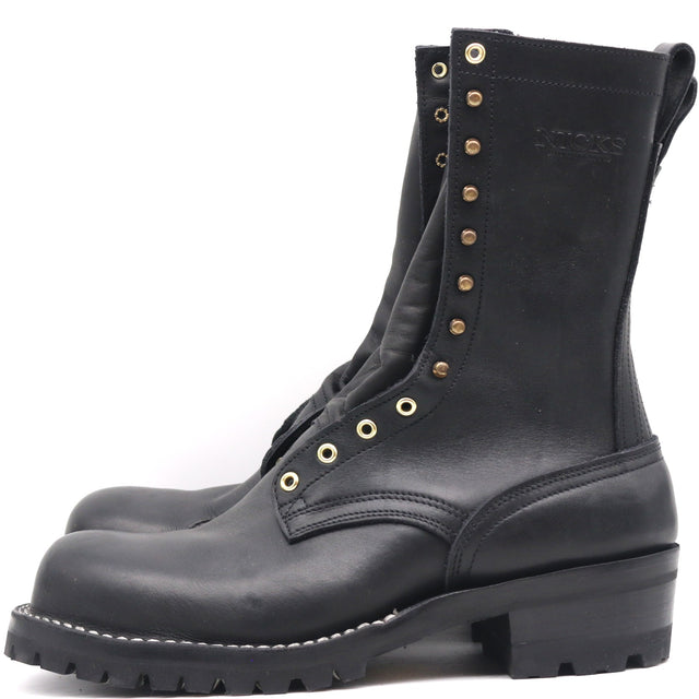 A pair of black leather lace-up boots with brass eyelets and studs, shown from a side profile view against a white background.