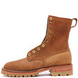 A single brown leather lace-up boot with brass eyelets, a pull tab, and a rugged lug sole, shown in a side profile on a white background.