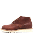 A single brown leather chukka boot with a textured grain finish, dark metal eyelets, and a thick off-white lug sole, shown from a side profile on a white background.