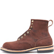 A brown suede ankle boot with brass eyelets, a pull tab, and a stacked black and tan sole, shown from a side profile on a white background.