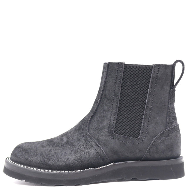 Black pull-on boot with rear pull loop and wedge outsole in front of a white background.