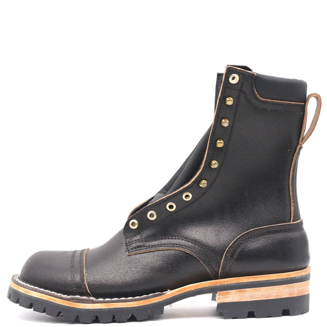 Black waxed leather boot with 4 row toe cap, brass hardware, and rear pull loop in front of a white background.