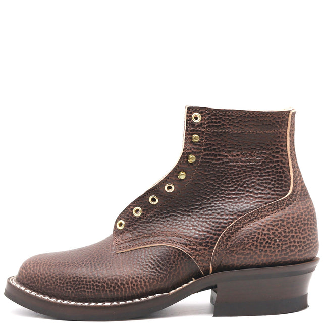 Dark brown textured bison leather boot with brass hardware and classic heel stack in front of a white background.