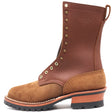 Tall brown leather work boot with brass hardware and lug outsole in front of a white background.