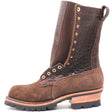 Tall brown textured shrunken bison leather boot with a padded gusset, brass hardware, rear pull loop, and lug outsole in front of a white background.