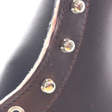 Close up of the hardware on the uppers of a leather boot showing small holes near the speedhooks caused by the hardware machine.