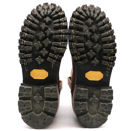 Bottom outsoles of Nicks Handmade Wellington boots showing black rubber heavy lug tread patterns and yellow Vibram logos