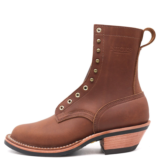 A brown leather lace-up ankle boot with brass eyelets, a pull tab, and a stacked wood-look heel, shown from a side profile on a white background. The brand 'NICK'S' is embossed on the side.