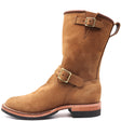 Tall engineer pull on boot with brass top and bottom buckles and rear pull loop in front of a white backround.