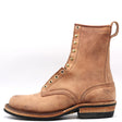 Tall light brown leather boot with rear pull loop, rolled top, and brass eyelets in front of a white background.