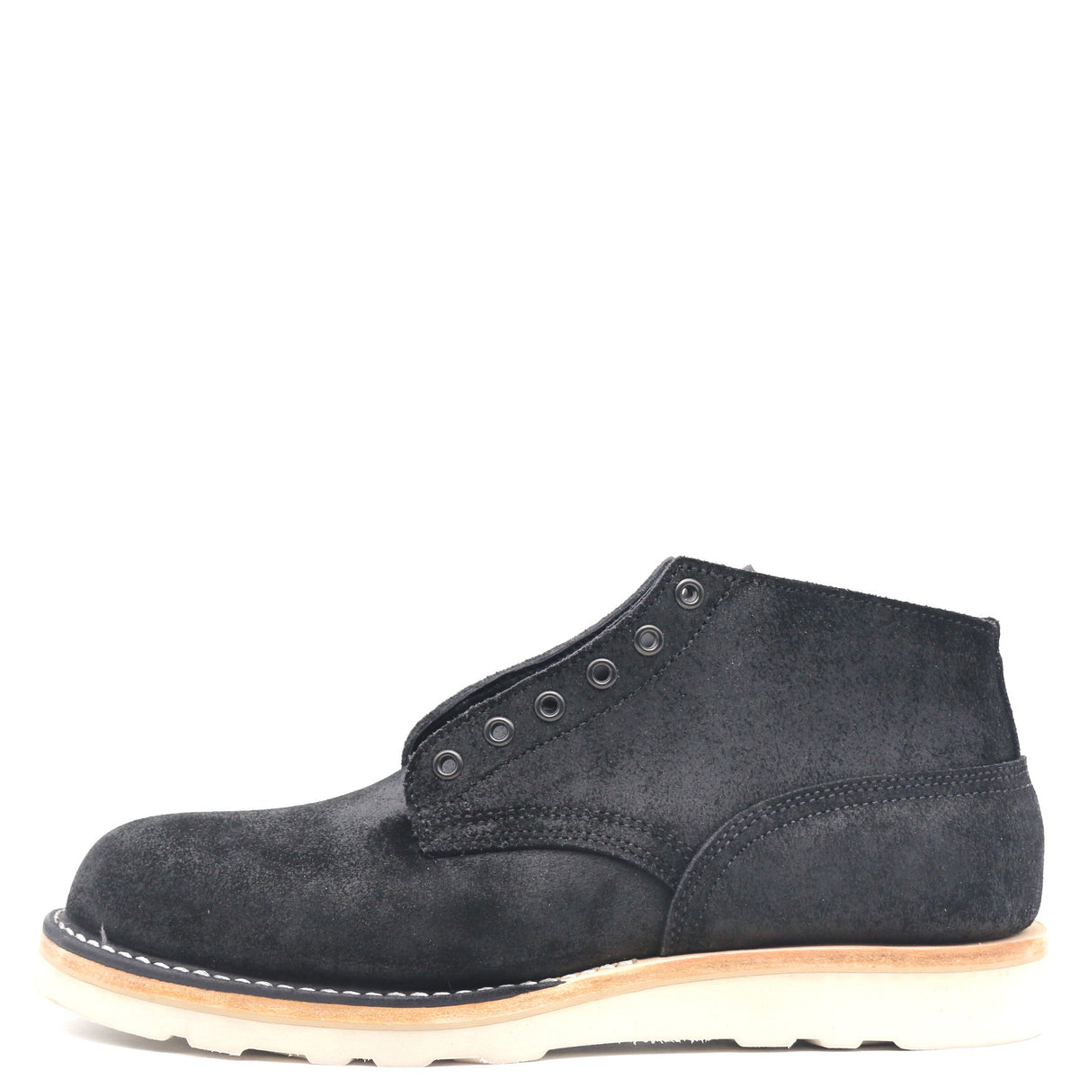 A single black suede chukka boot with metal eyelets and a thick off-white sole, shown from a side profile on a solid white background.