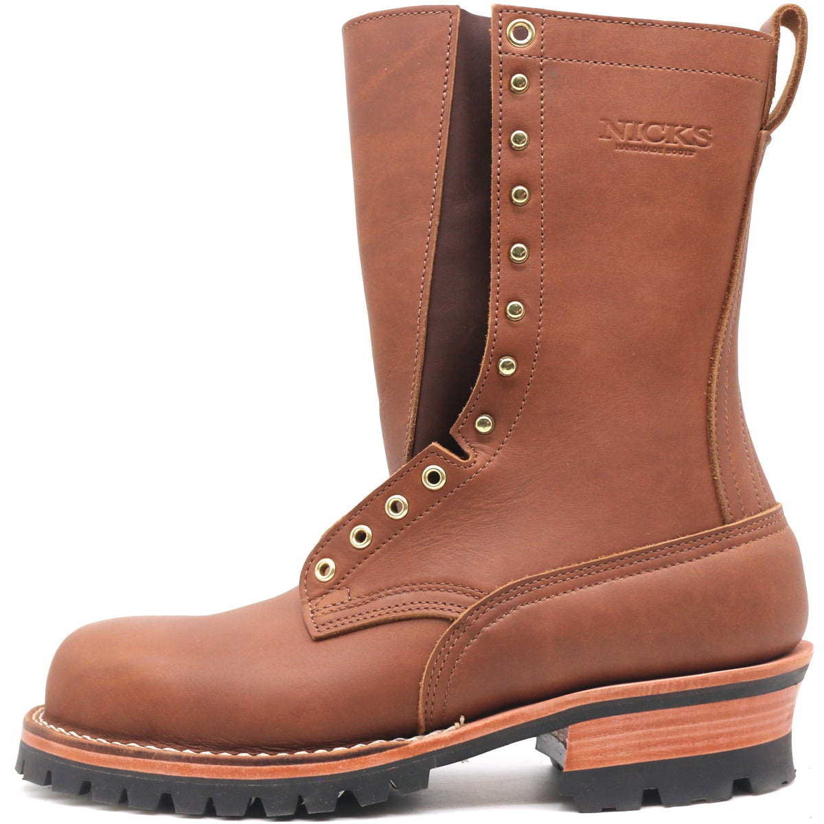 A brown leather work boot with a rugged black lug sole, a stacked wood-look heel, and brass eyelets, shown on a white background. The brand 'NICKS' is embossed on the side.