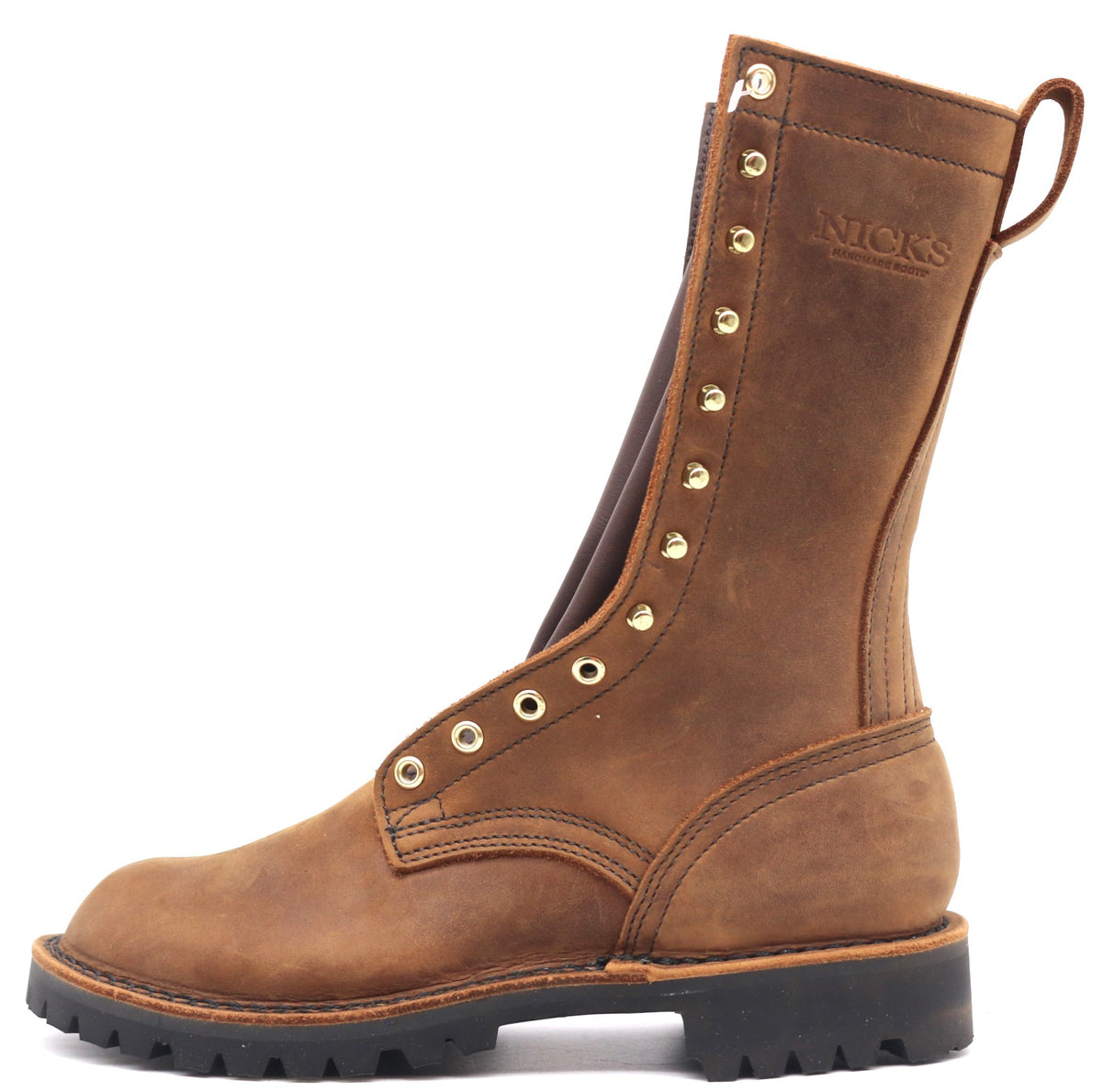 A brown leather mid-calf work boot with gold-tone metal eyelets and studs, featuring a pull tab and the brand name 'NICKS' embossed on the side, set against a plain white background.