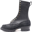 A black leather and suede lace-up boot with brass eyelets and studs, featuring a chunky black heel and a pull tab, shown against a plain white background.