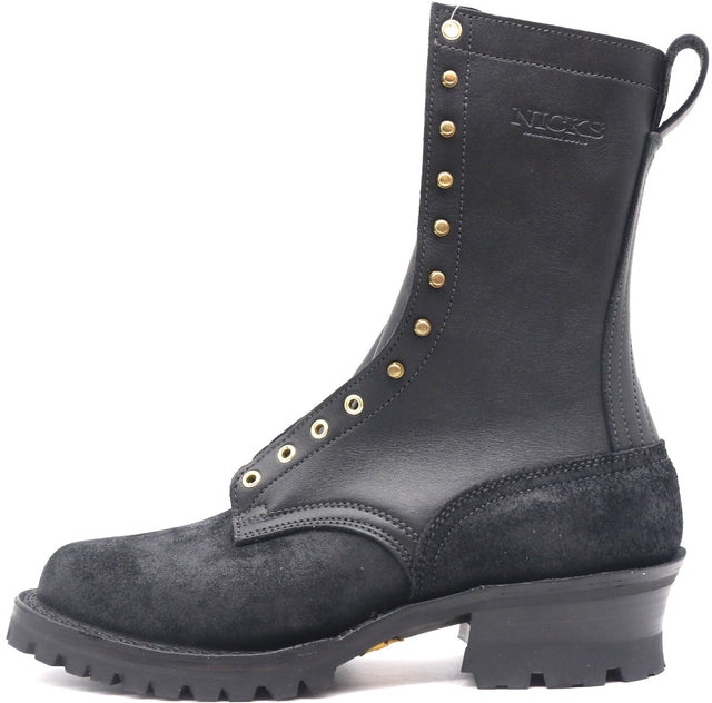 A black leather and suede lace-up boot with brass eyelets and studs, featuring a chunky black heel and a pull tab, shown against a plain white background.