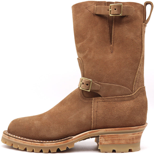 A brown suede mid-calf work boot with buckle straps, a rugged lug sole, and a stacked wood-look heel, shown from a side profile on a white background.