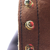 Close-up of a brown suede or nubuck strap with black stitching and three gold-tone metal rivets, shown against a white background.