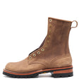 A brown suede lace-up ankle boot with brass eyelets, a pull loop, and a rugged black lug sole, shown from a side profile on a white background.