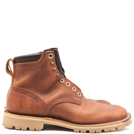 A single brown leather lace-up boot with a pull tab, metal eyelets, and a thick tan lug sole, shown in profile against a plain white background.
