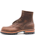 Brown leather moccasin toe ankle boot with rolled top, antique hardware, and black outsole in front of a white background.