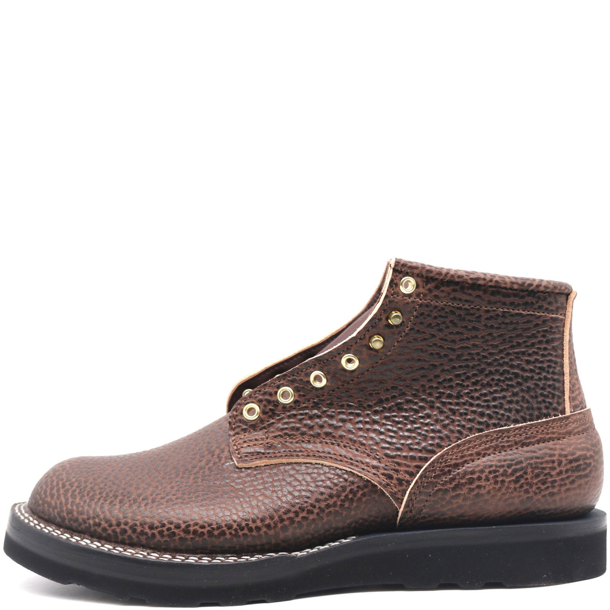 Brown textured bullhide leather ankle boot with rolled top, brass hardware, and black wedge outsole in front of a white background.