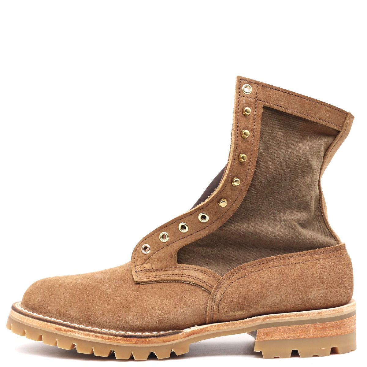 A brown suede and canvas ankle boot with brass eyelets, a chunky lug sole, and a stacked wood-look heel, shown from the side on a white background.