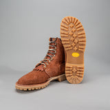 Shrunken bison brown leather Bear Slayer with brown padded collar, honey vibram outsole and 4 relief notches. Left boot propped up showing Honey vibram outsole.