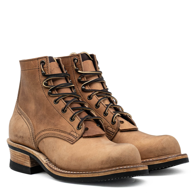 Tan distressed leather lace-up work boots with dark laces metal eyelets stacked heels and thick rubber soles