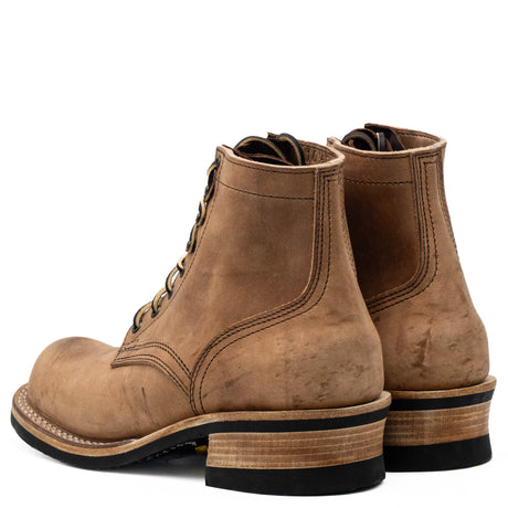 A pair of brown suede lace-up ankle boots with stacked wood-look heels and black soles, shown from a three-quarters angle on a white background.