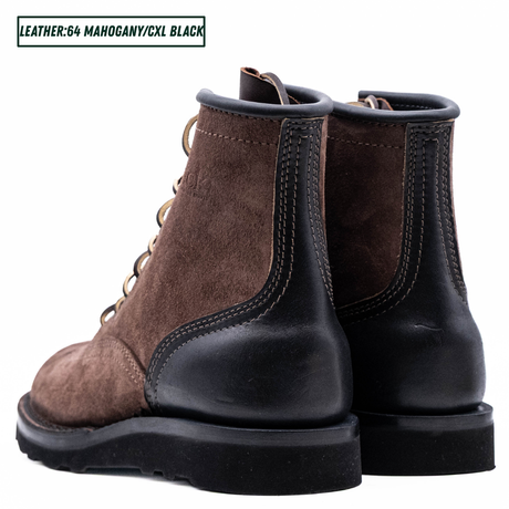 A pair of brown suede lace-up work boots with black leather single piece backstay. A text label in the top left reads 'LEATHER:64 MAHOGANY/CXL BLACK'.