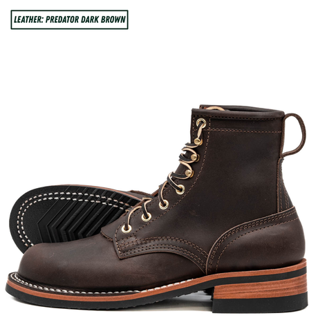 A pair of dark brown leather lace-up boots shown on a white background, with one boot standing upright and the other lying on its side to display the sole tread. A text label in the top-left corner reads 'LEATHER: PREDATOR DARK BROWN'.