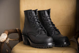 Black Becca boots with lug soles on chair