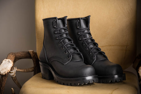 Black Becca boots with lug soles on chair
