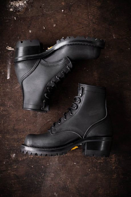 Black Becca boots with lug soles on floor