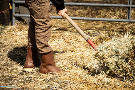 Brown chore boot being worn while doing chores around the farm