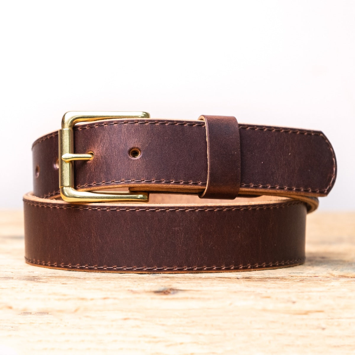 Brown belt on wooden table