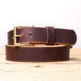 Brown belt on wooden table